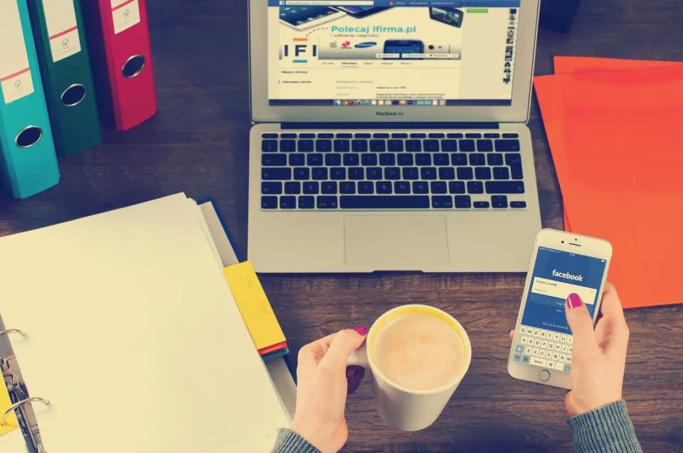 Laptop and smartphone on a desk, two of the easiest electronics to flip